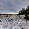 Menai Bridge at low tide with iced rocks and algae