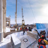 Fixing a cross on the dome of church
